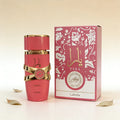 Lattafa Yara Candy perfume bottle and box in vibrant pink with gold accents, featuring a floral design on packaging.
