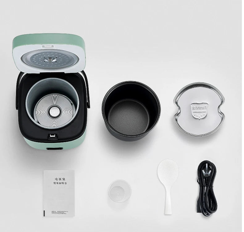 Mini electric rice cooker in teal with inner pot, lid, and included accessories