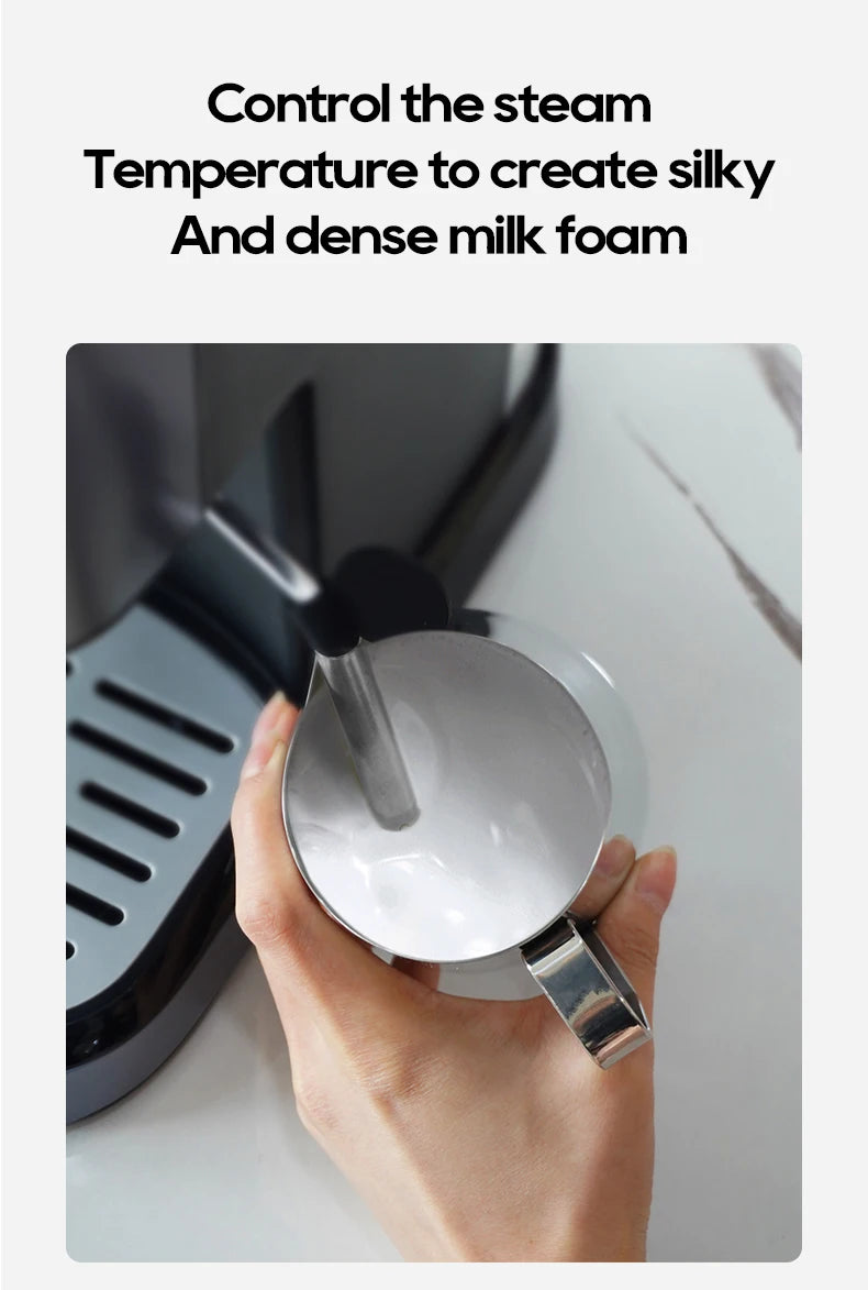 Stainless steel espresso machine steam wand frothing milk in a silver pitcher for dense, silky foam.
