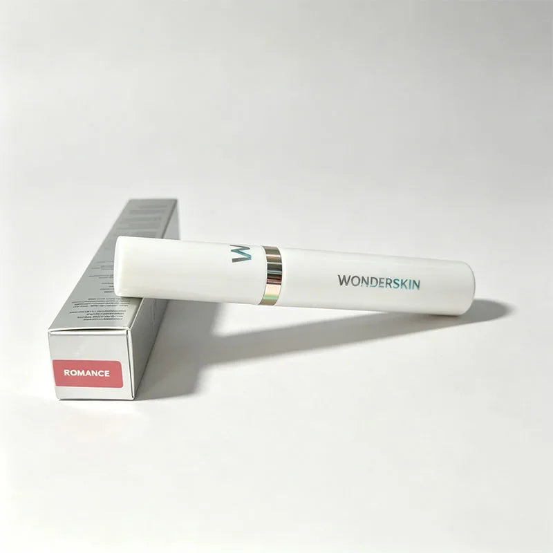Wonderskin peel-off lip stain in Romance pink shade. Long-lasting, waterproof liquid lip makeup in sleek white tube.