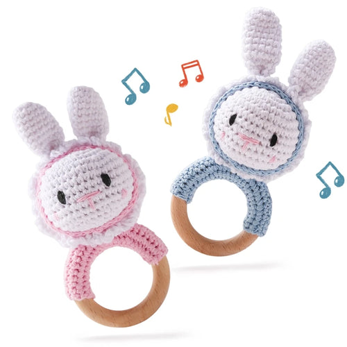 Pink and blue bunny teething rings for babies made of natural wood and crochet yarn.