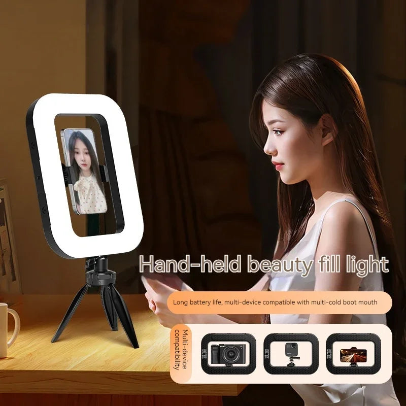 Rectangular LED fill light on a tripod stand, holding a smartphone for video recording and content creation.
