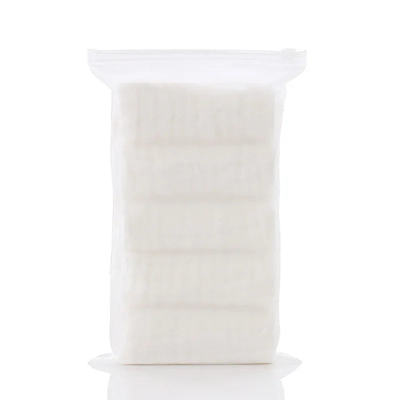 Pack of soft, disposable baby care cotton wipes in a clear, resealable travel pouch for gentle skincare.
