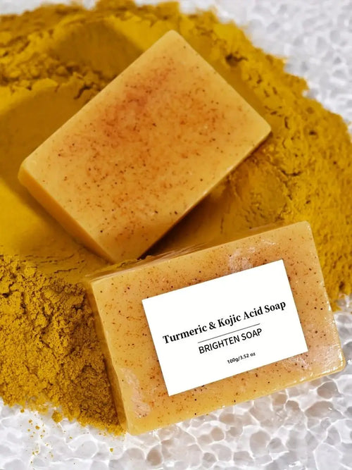 Anti-inflammatory yellow turmeric & kojic acid soap bars (100g) on yellow powder.