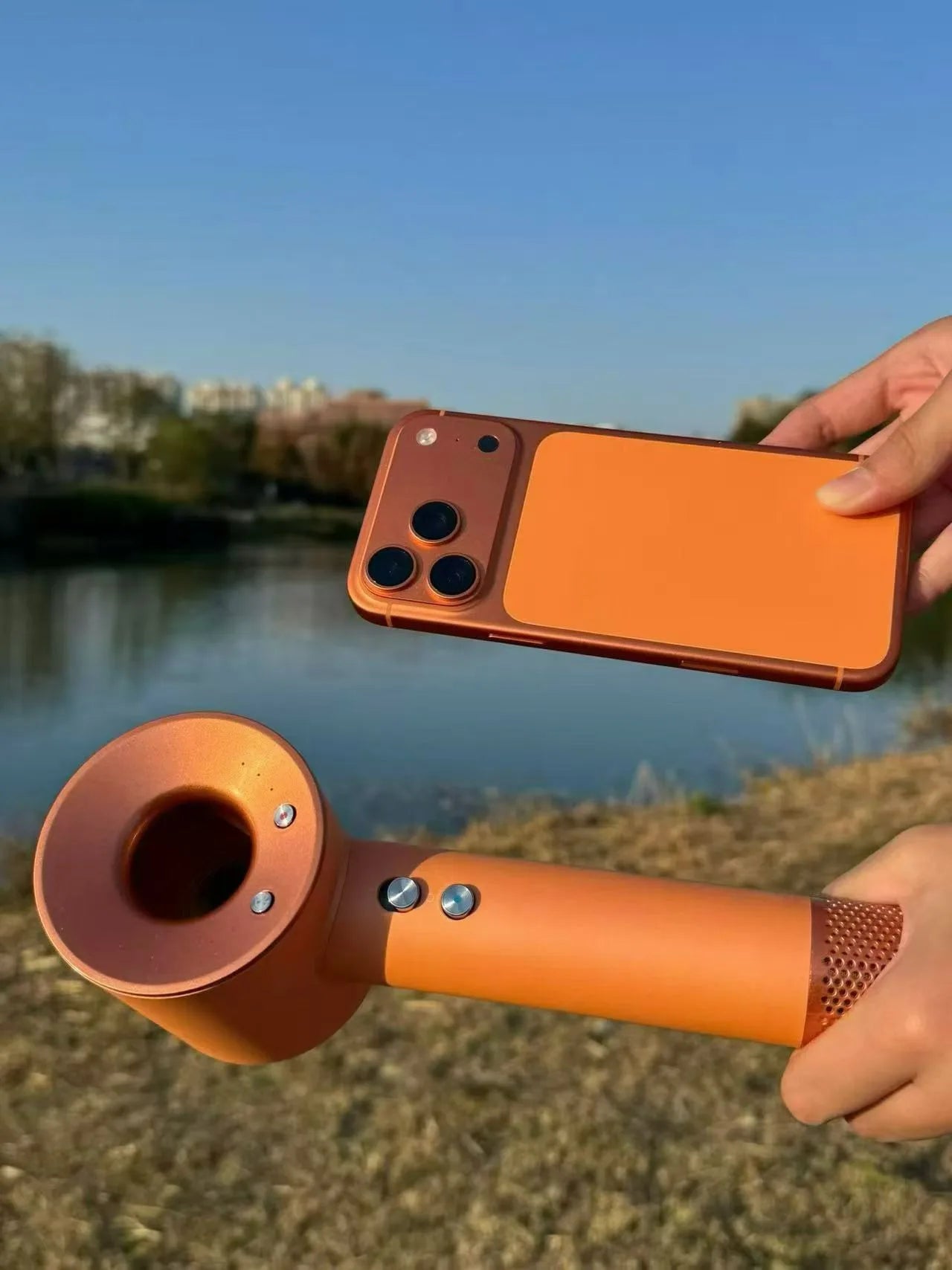 Orange high-speed hair dryer with brushless motor, negative ion tech, and sleek ergonomic design for fast drying.