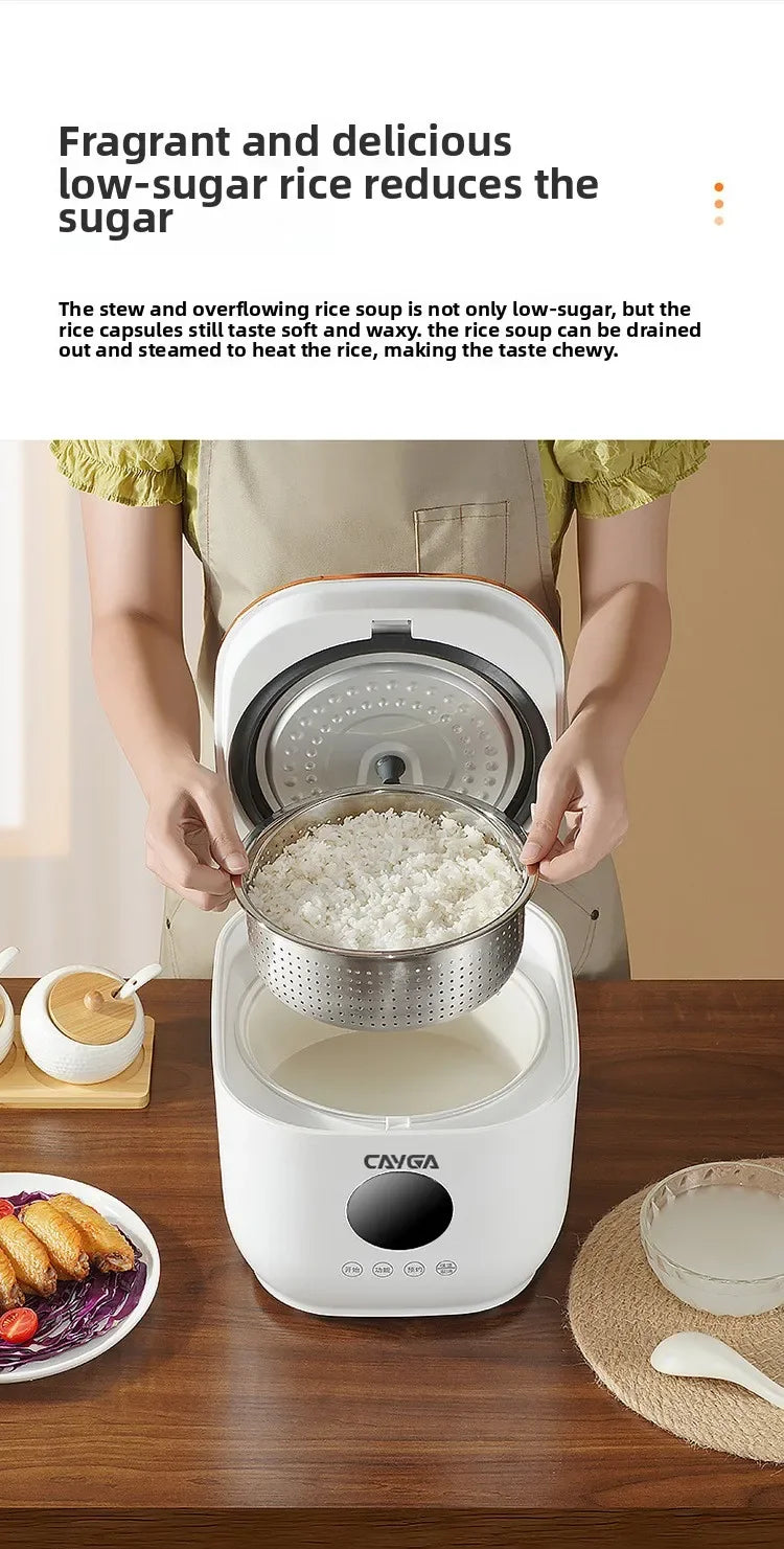 White rice cooker with lid open showing inner pot of cooked rice and steaming basket