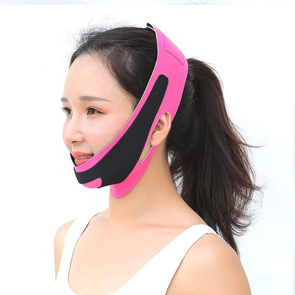 Woman wearing a bright pink and black elastic V-line face slimming bandage strap over her chin and cheeks.