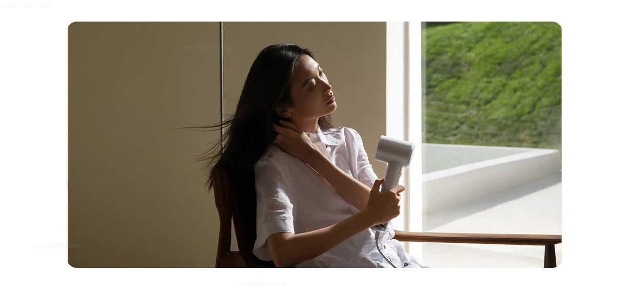 Woman using a white Mijia H501 high-speed negative ion hair dryer for quick, professional-grade hair styling.