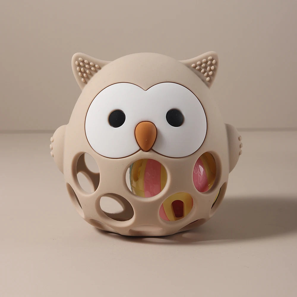Beige owl silicone teething toy for baby teething relief.