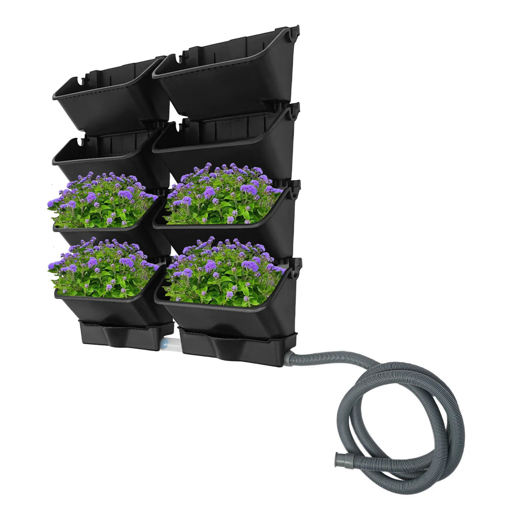 Vertical wall-mounted planter set with six black pockets and purple flower plants