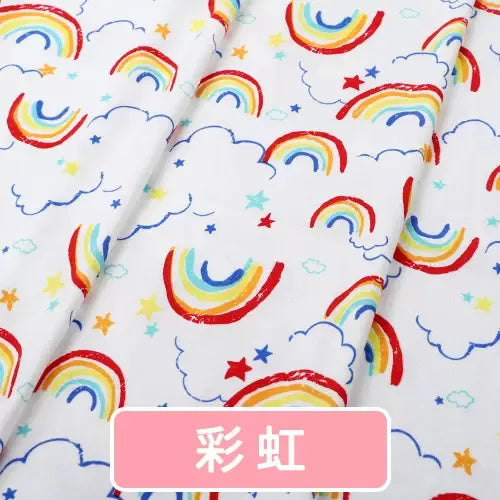 Tidesmit white knit jersey fabric featuring a colorful rainbow, cloud, and star print for baby garment sewing.