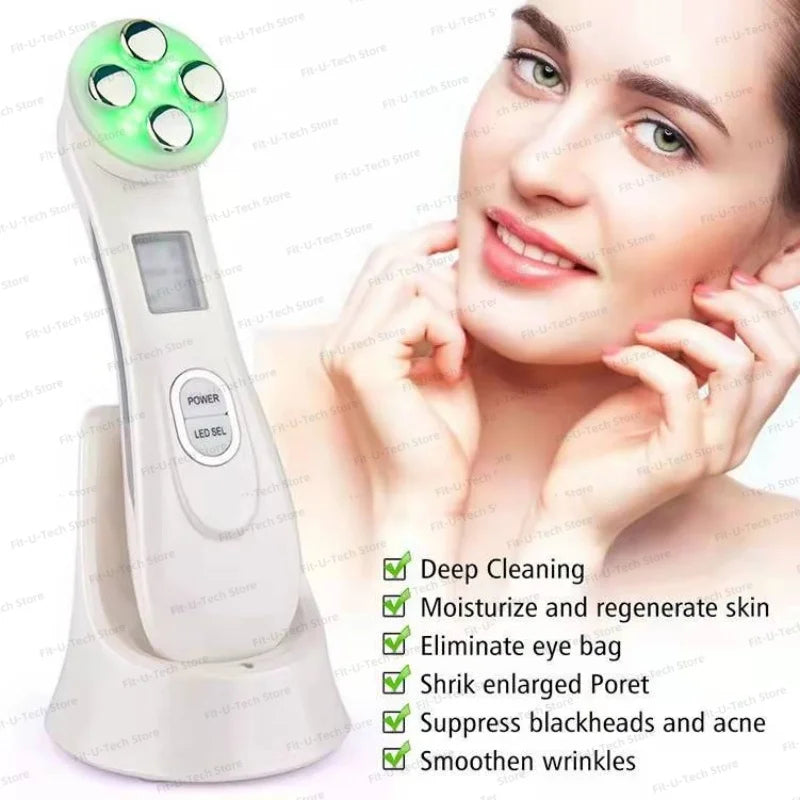 White EMS facial massager with a four-sphere head glowing green, sitting on a charging stand next to a smiling woman.