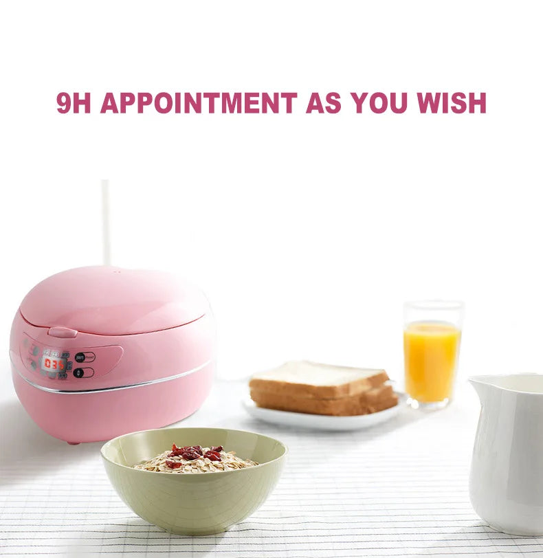 Pink heart-shaped rice cooker with lid open and front digital control panel