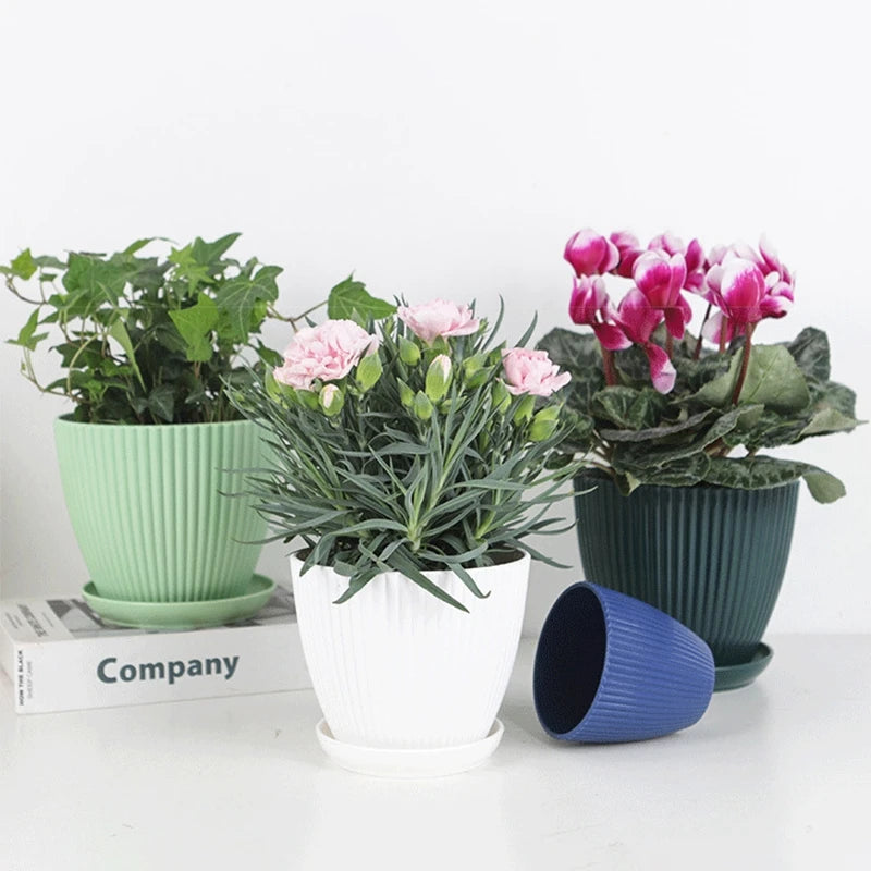 Plastic plant pot with tray set, ribbed mint and dark teal; styled with flowers