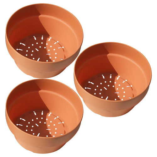 Set of three terracotta-orange shallow planters, view from top showing drainage holes
