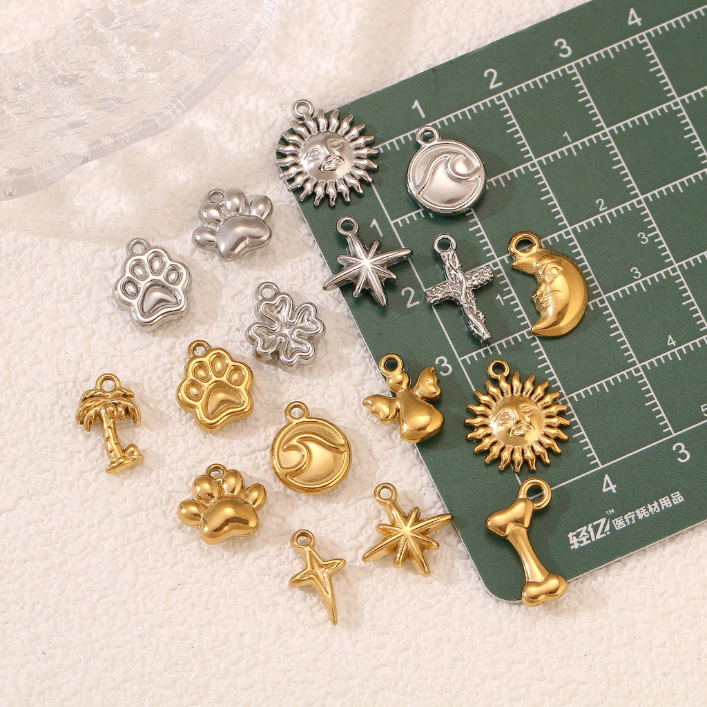 Stainless steel pet paw, star, and wave charms for DIY jewelry making, necklace, and bracelet designs.