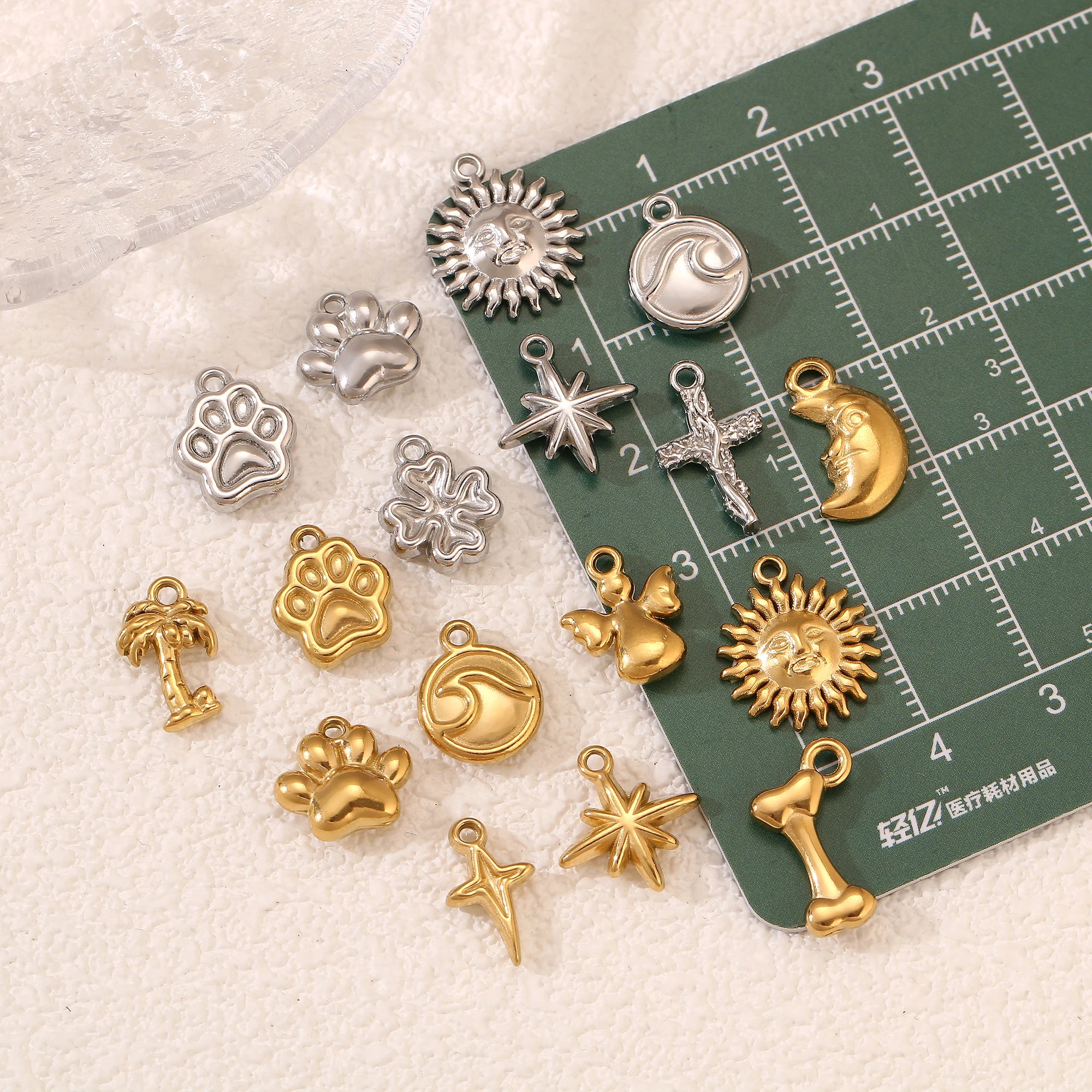 Stainless steel pet paw, star, and wave charms for DIY jewelry making, necklace, and bracelet designs.