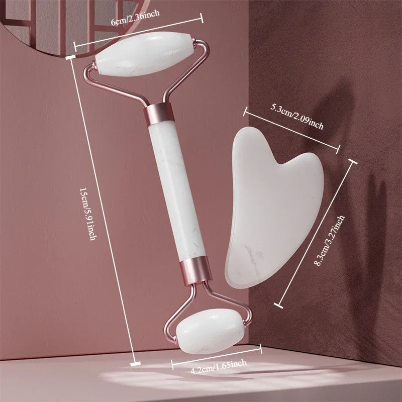 White marble face massage roller with gold metal handle and matching heart-shaped gua sha tool with size labels.