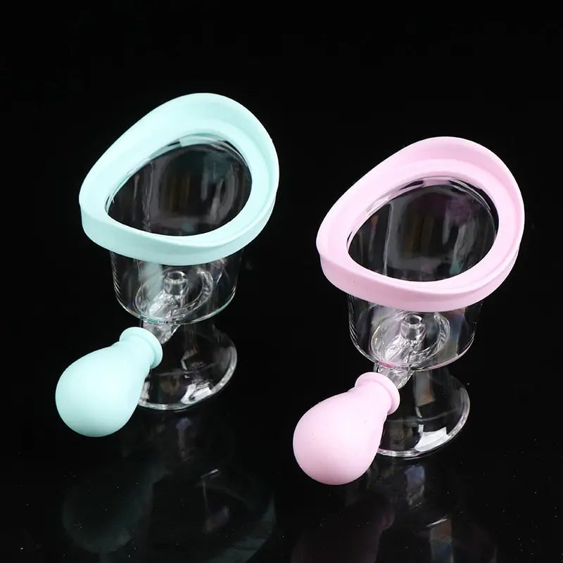 Reusable silicone eye wash cups with squeeze bulbs for rinsing and cleaning eyes, in pastel blue and pink colors.