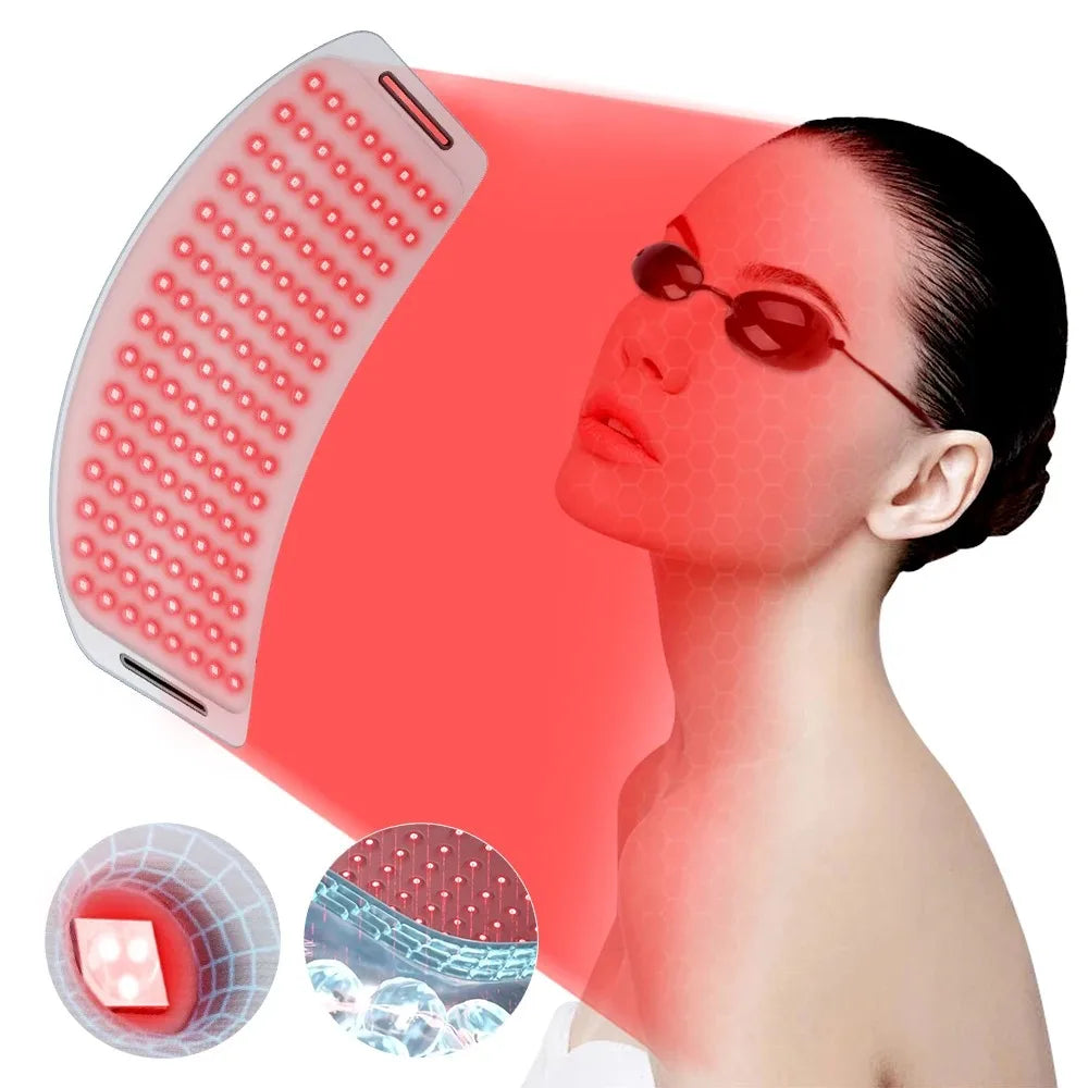 A person wearing protective goggles receives light therapy from a curved, white LED panel emitting red light.