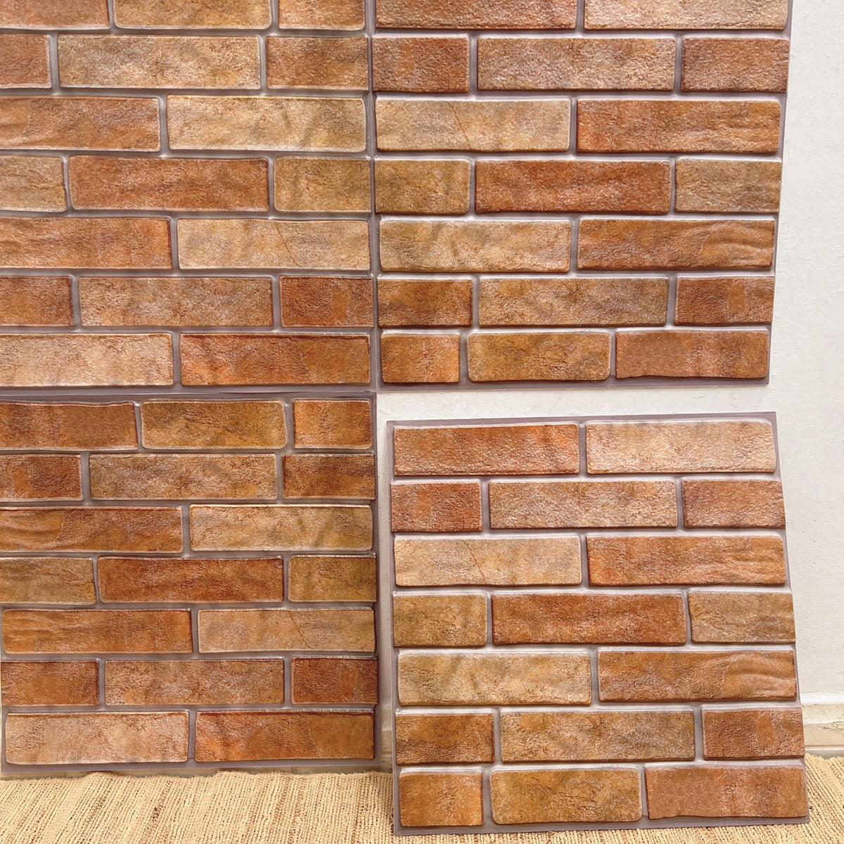 Terracotta brick-style peel-and-stick backsplash tile sheet with grout lines