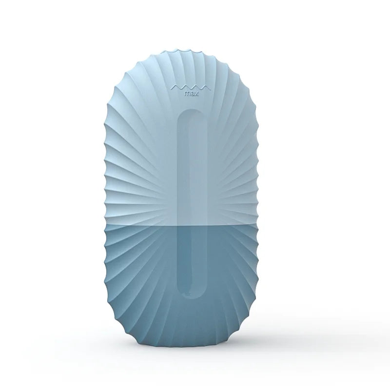 Oval, pleated blue silicone ice roller mold for face, featuring a "max" fill line indicator.