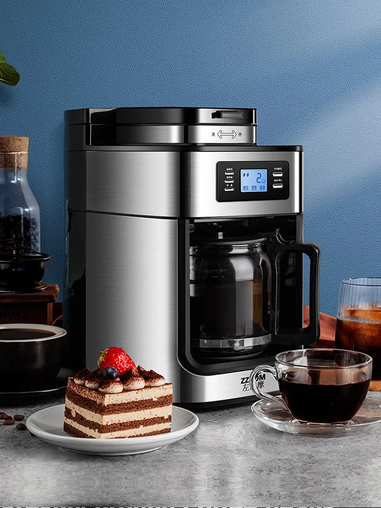 ZZOM stainless steel digital coffee maker with glass carafe and LCD display on a kitchen table with dessert.