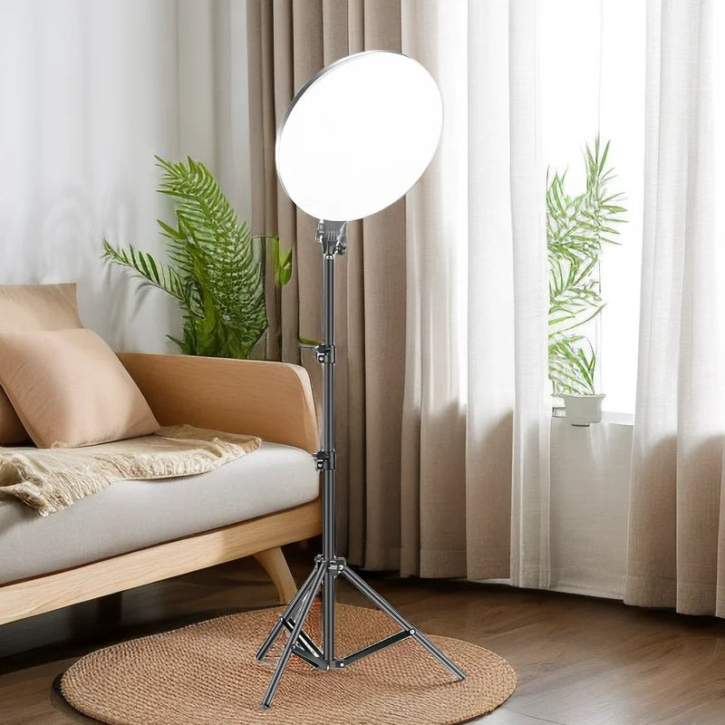 Round LED ring light on an adjustable metal tripod stand for photography and video lighting.