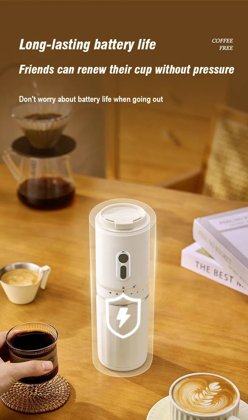 Portable white battery-powered coffee grinder with sleek cylindrical design on a wooden table with coffee cups.