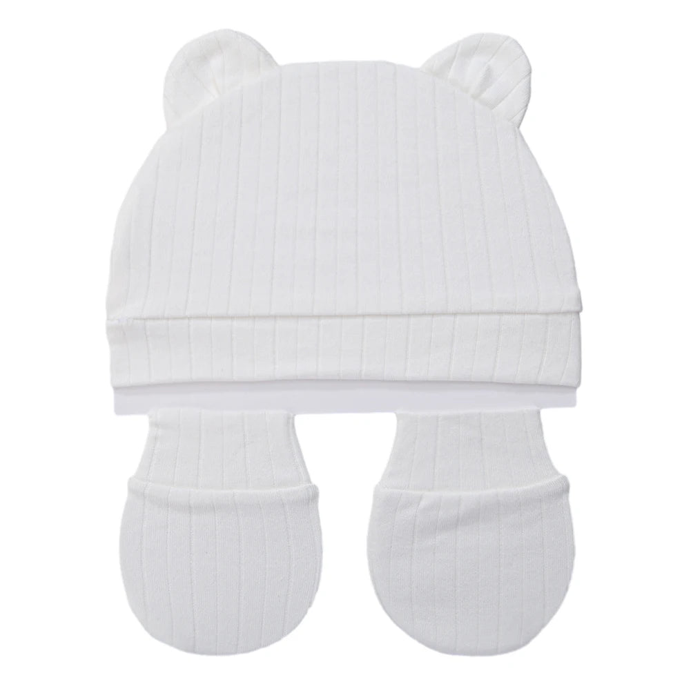 Tidesmit 3-piece newborn set in ribbed white cotton featuring a bear-ear hat and two baby mittens.
