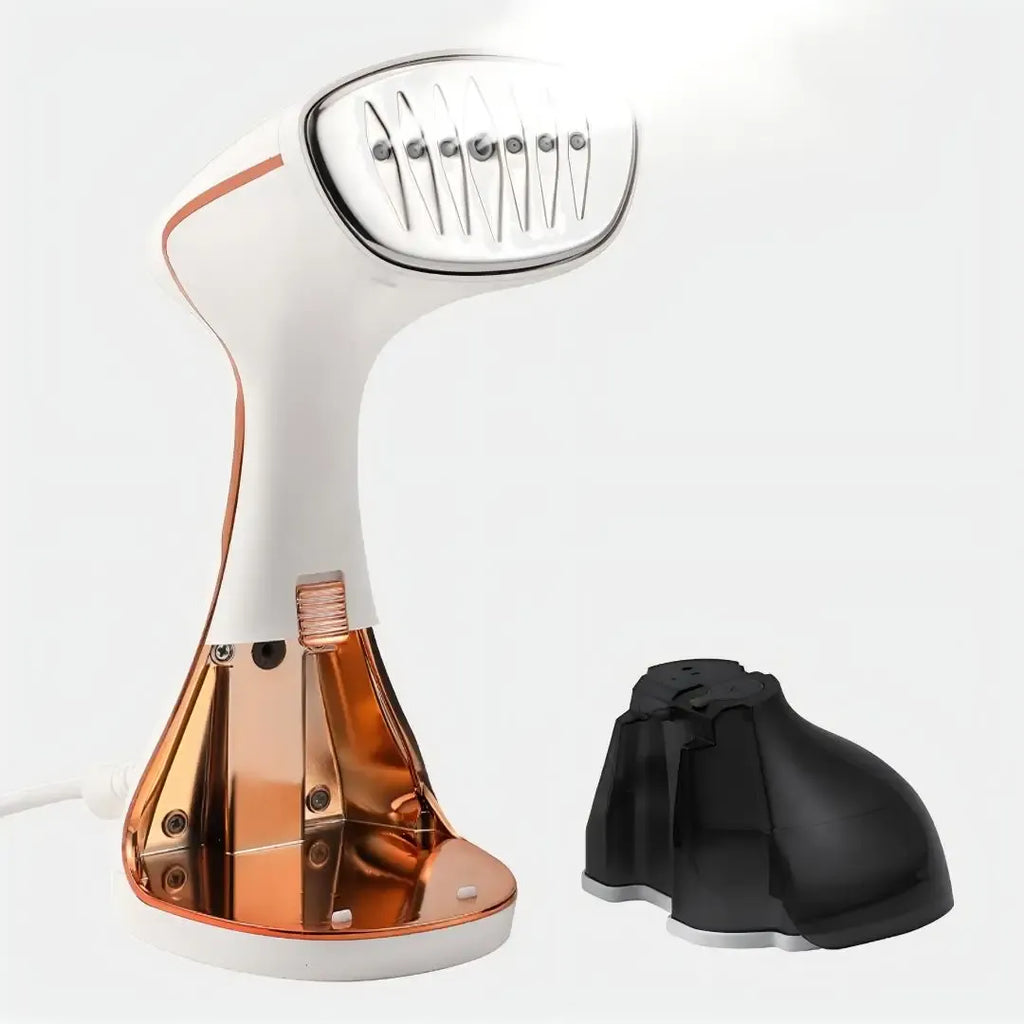 Handheld garment steamer with white and rose gold body, metal steam plate, and detached black water tank.