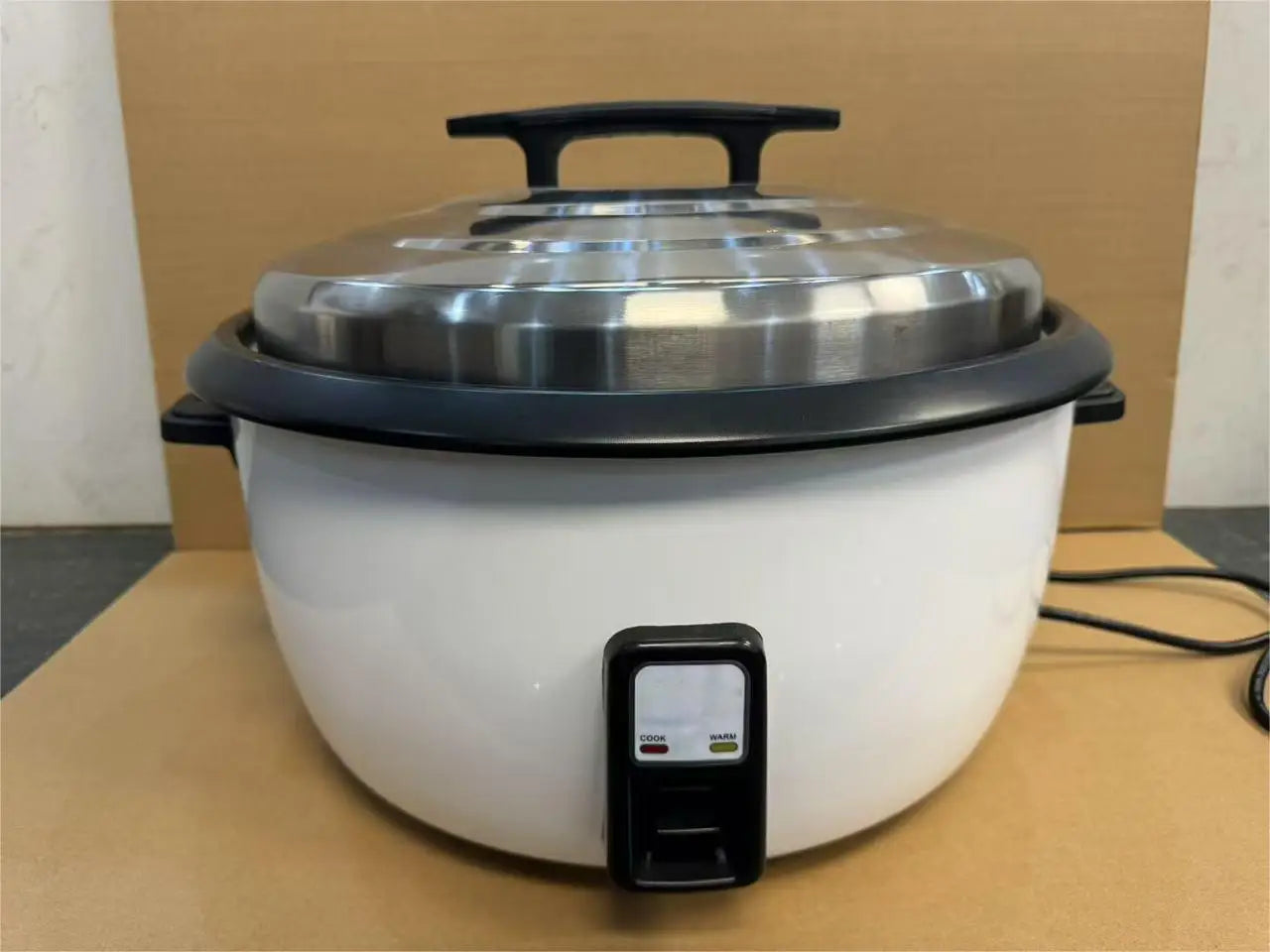 Commercial electric rice cooker with black side handle, front control box, and lid
