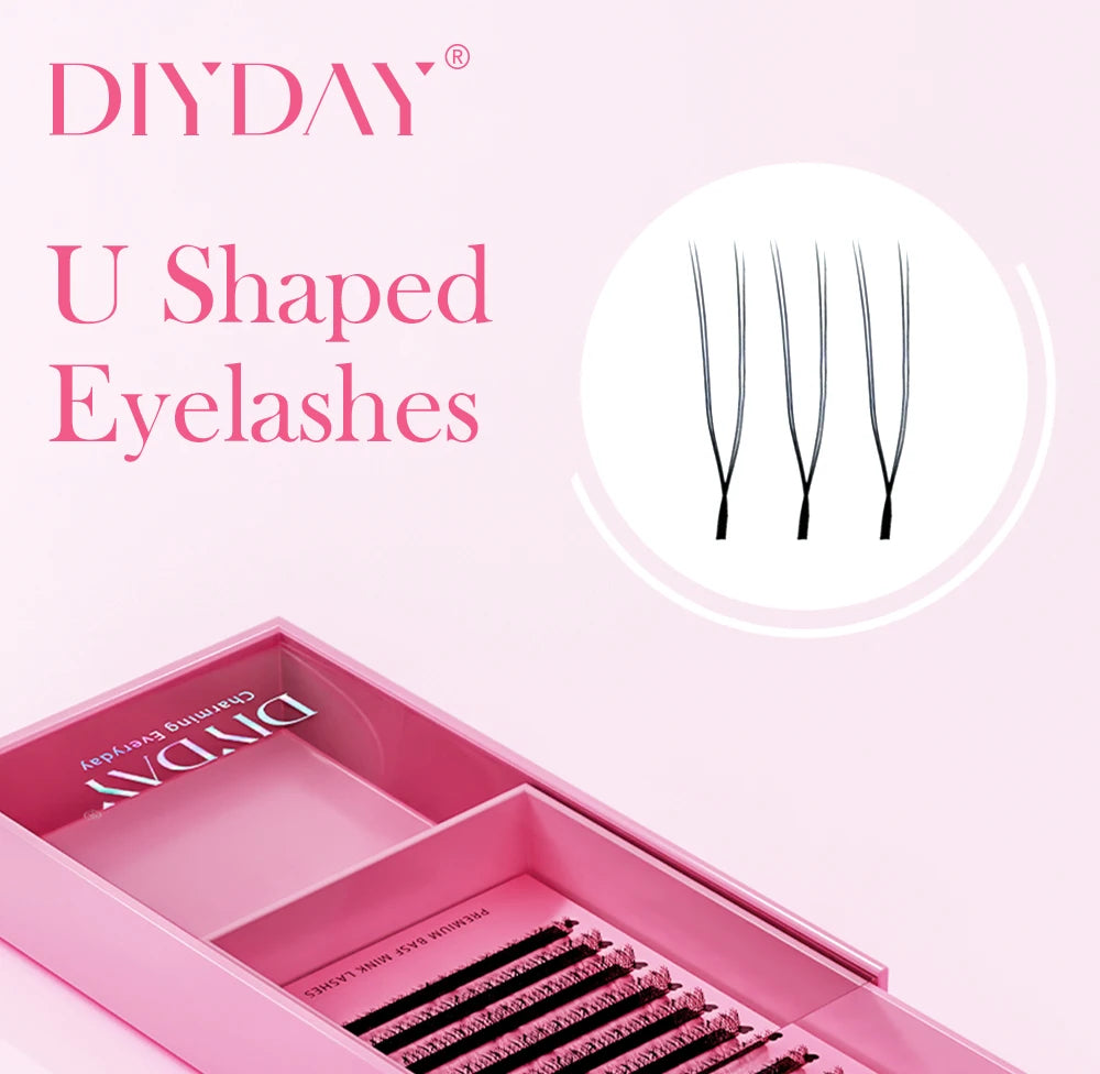 DIYDAY U-shaped black YY eyelashes in a pink packaging tray against a light pink background.