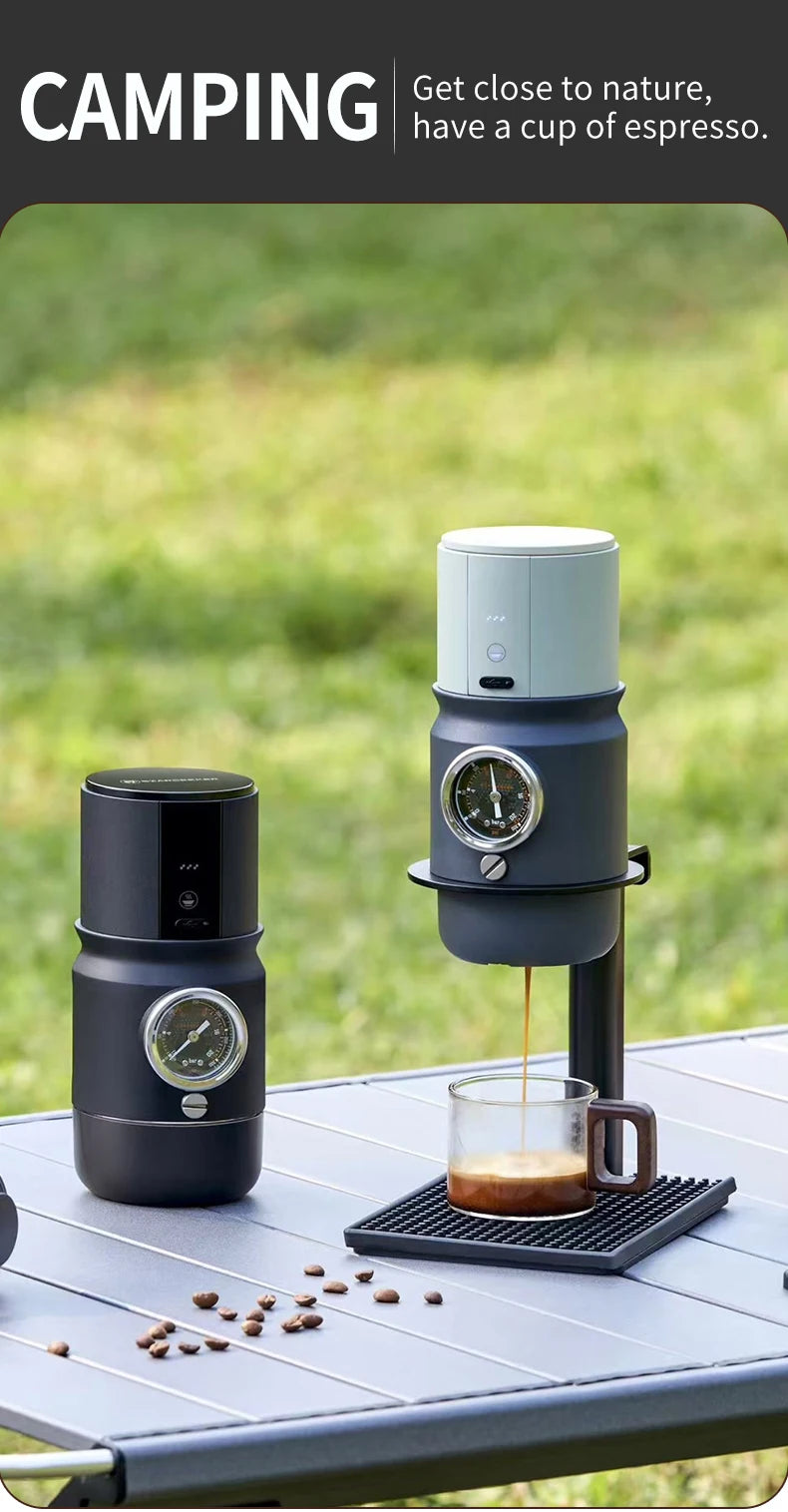 Portable camping espresso maker set in black and grey, featuring built-in pressure gauges and a glass coffee cup.