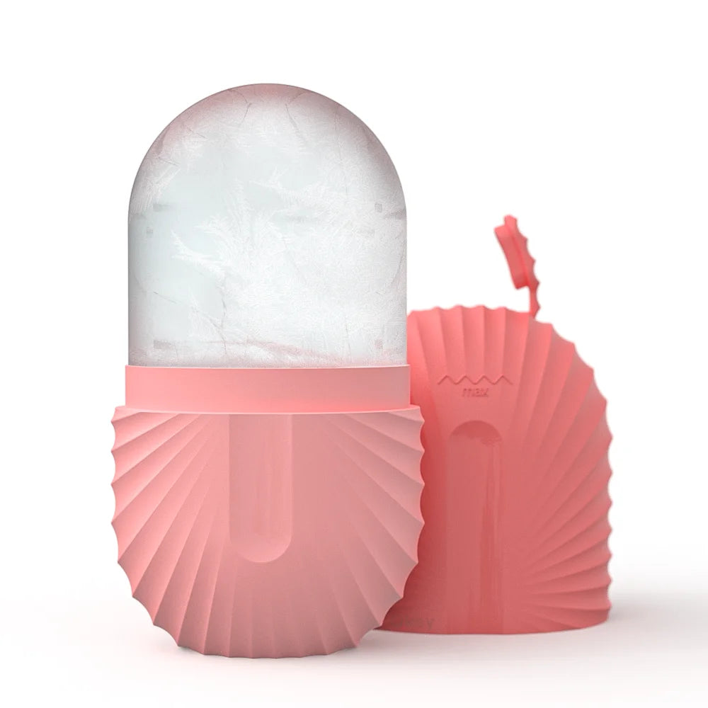 A pink, ribbed silicone facial ice roller with a rounded frozen ice core, shown next to its matching removable cap.