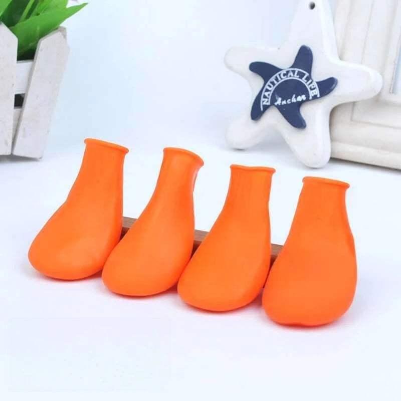 4 waterproof orange rubber dog boots for small to large pets. Durable, anti-slip paw protectors for rainy weather.