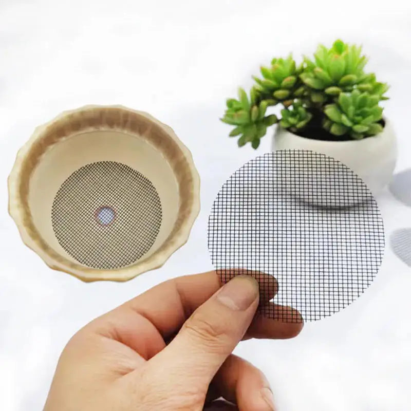 Set of round beige mesh drainage screens with grid, one held by a hand