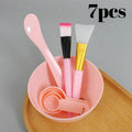 7-piece pink facial mask DIY tool kit with mixing bowl, spatulas, brushes, and measuring spoons.