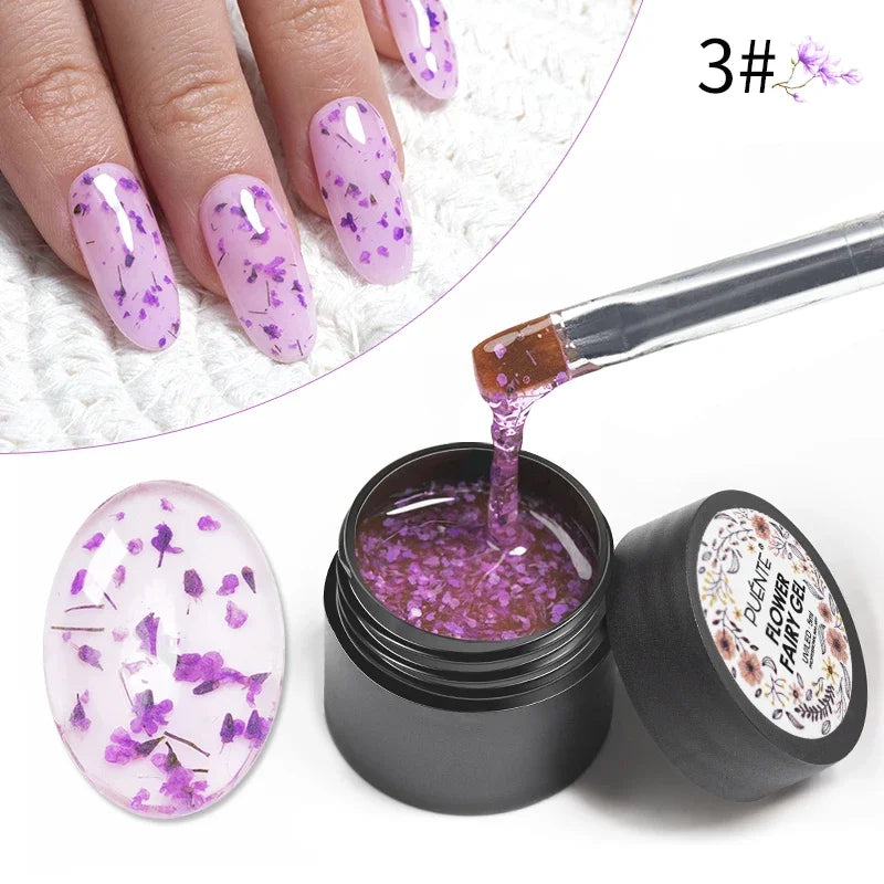 Purple flower nail art gel in a black jar, shown applied to fingernails and being lifted by a brush.