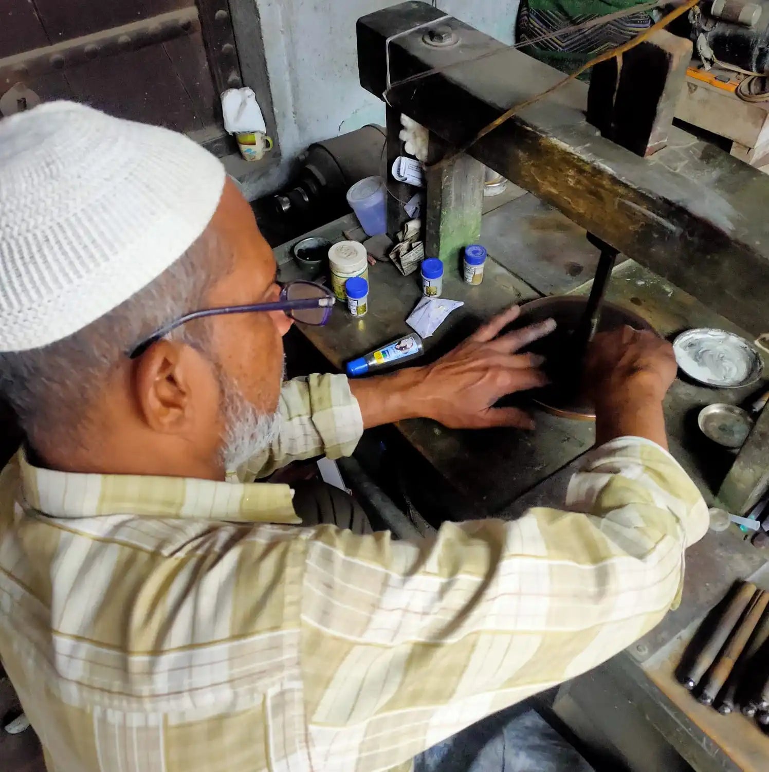 Jewelers hands working at a workbench with gemstone tools