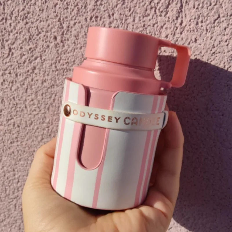 Armaf Odyssey pink striped EDC candle, 100ml cylindrical design, Arabian fragrance aesthetic, hand-held home scent.