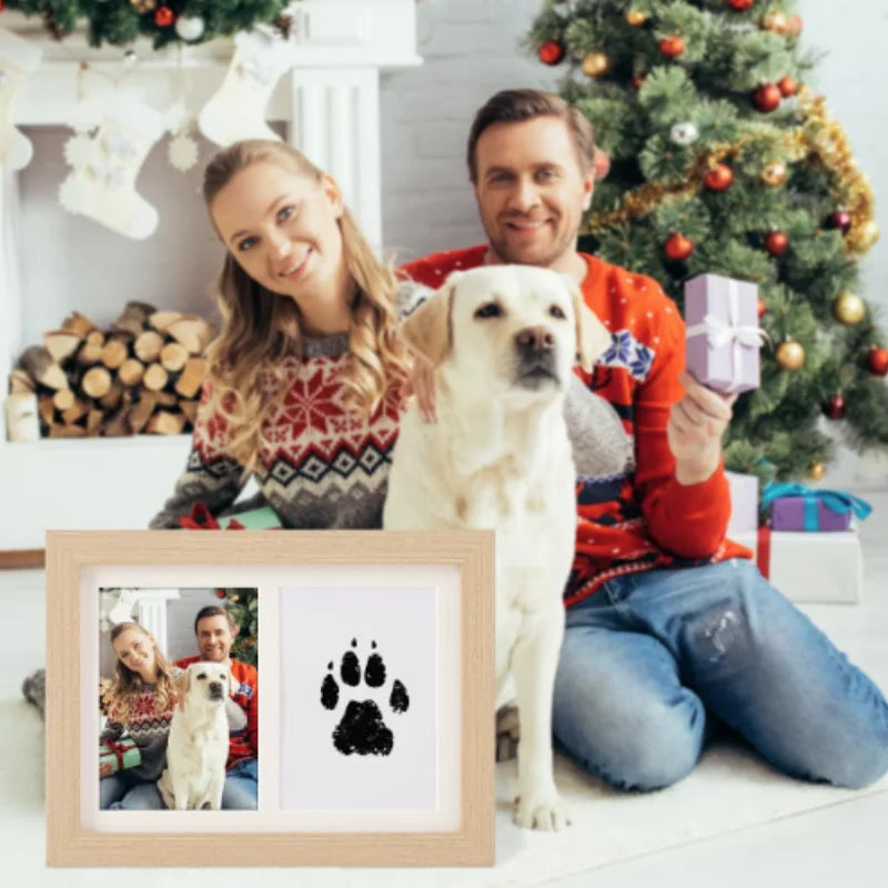 Non-toxic inkless ink pad kit for pet dog paw print souvenirs in a wooden frame with a family photo.