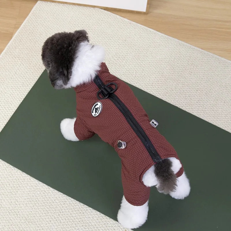 Small dog wearing a brown waterproof winter jumpsuit with a back zipper for warm, comfortable outdoor protection.