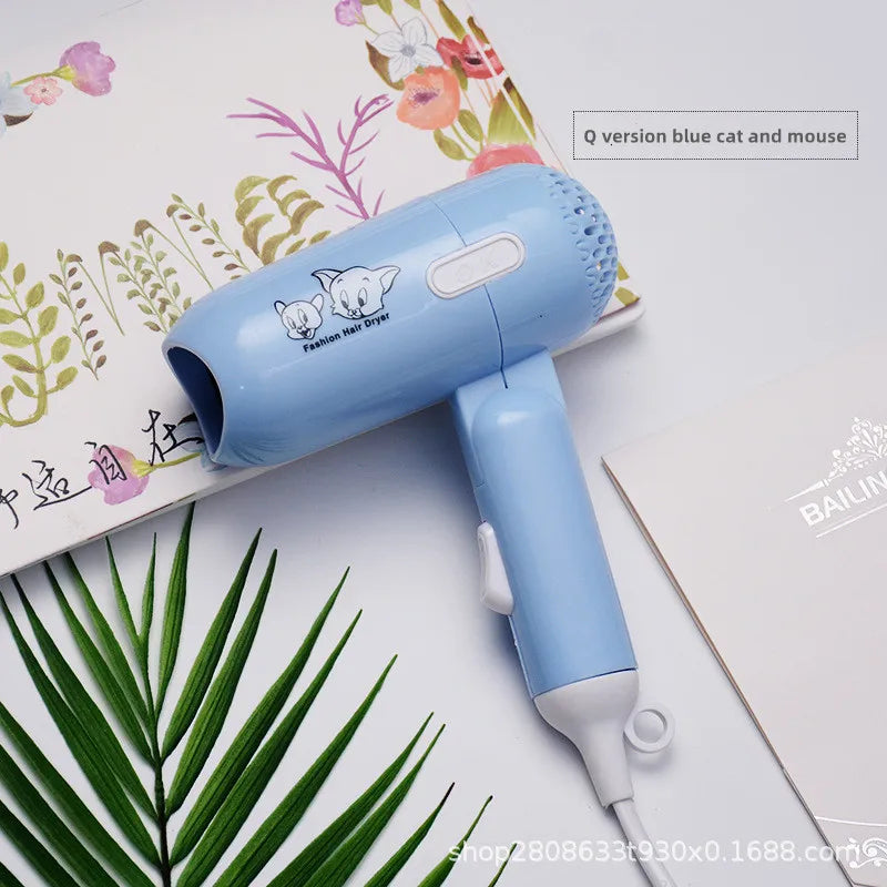 Blue foldable mini hair dryer with cartoon cat print, ionic quick-dry technology, and portable travel-friendly design.