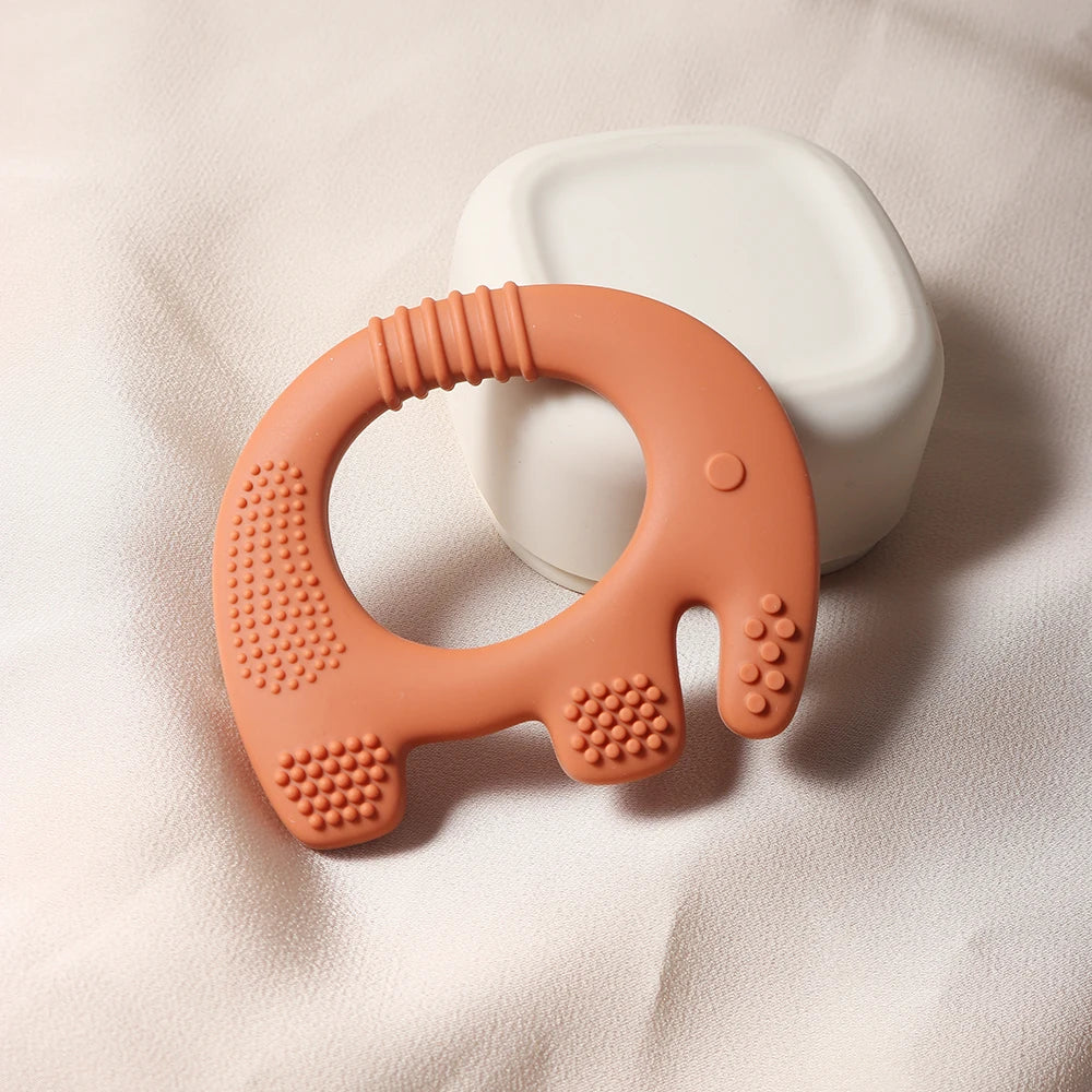 Rust orange silicone elephant baby teething ring toy for infant relief.