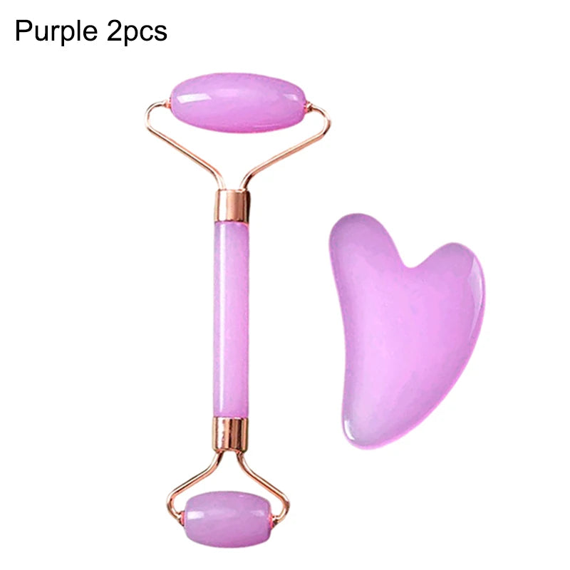 Purple jade facial roller and heart-shaped gua sha massage tool with rose gold accents.