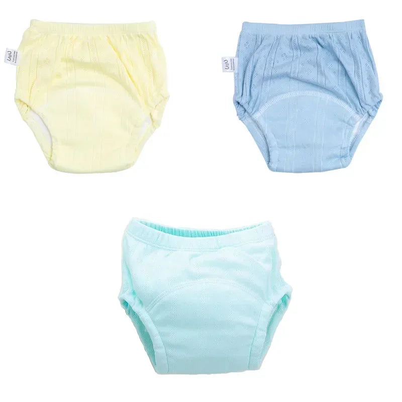 Set of 3 pastel baby training diapers in yellow, blue, and mint with breathable cotton design.