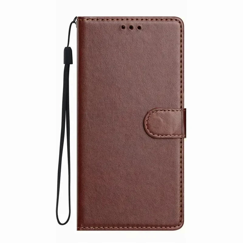 Brown leather wallet phone case with magnetic clasp and black wrist strap for protective storage and carrying.