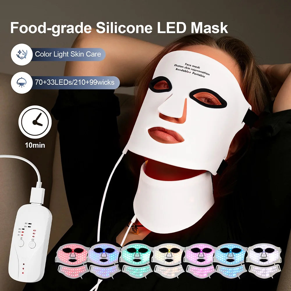 A person wearing a flexible white silicone LED mask and neck piece, connected to a handheld remote controller.