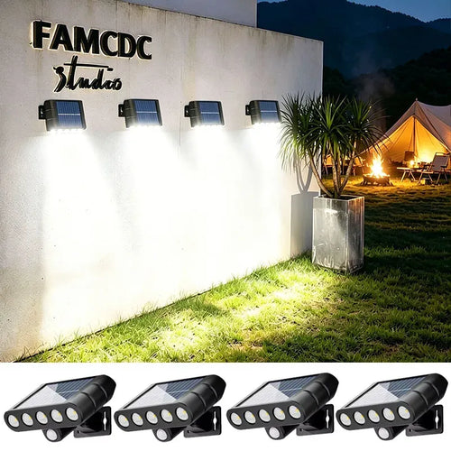Four black solar-powered LED wall lights mounted on an outdoor white wall, casting bright downward illumination.